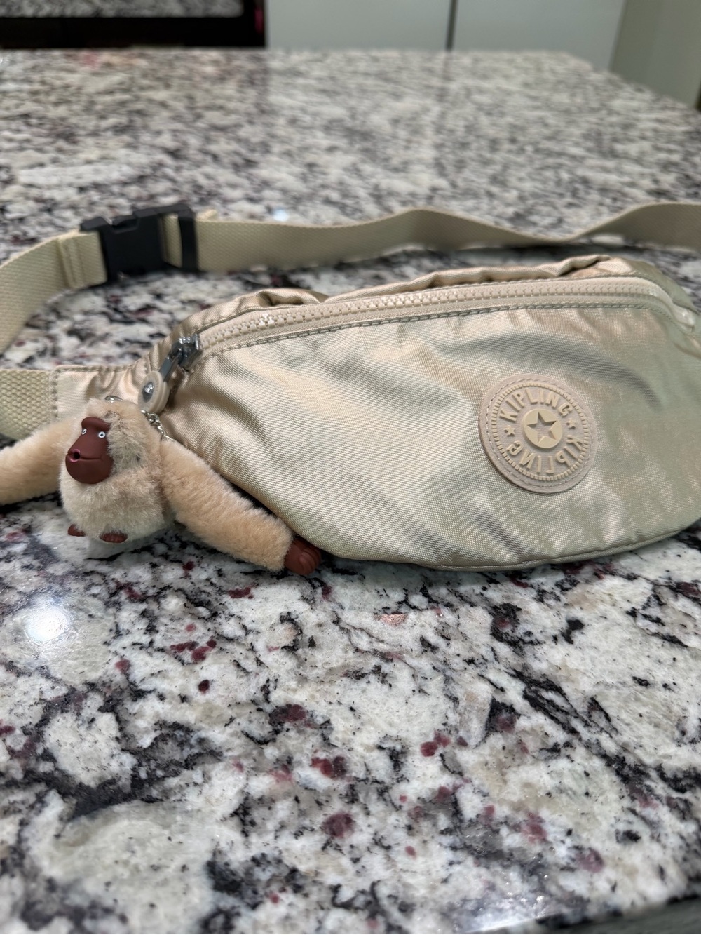 Kipling Metallic Champagne Belt Bag with Monkey Charm